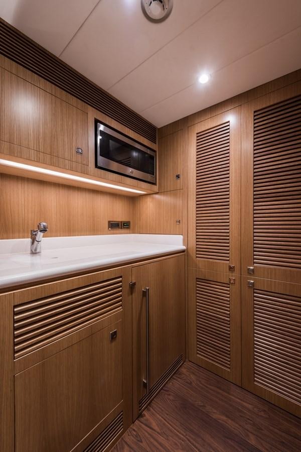 a kitchen with wooden cabinets aboard E84 (NEW BOAT SPEC)  Yacht for Sale