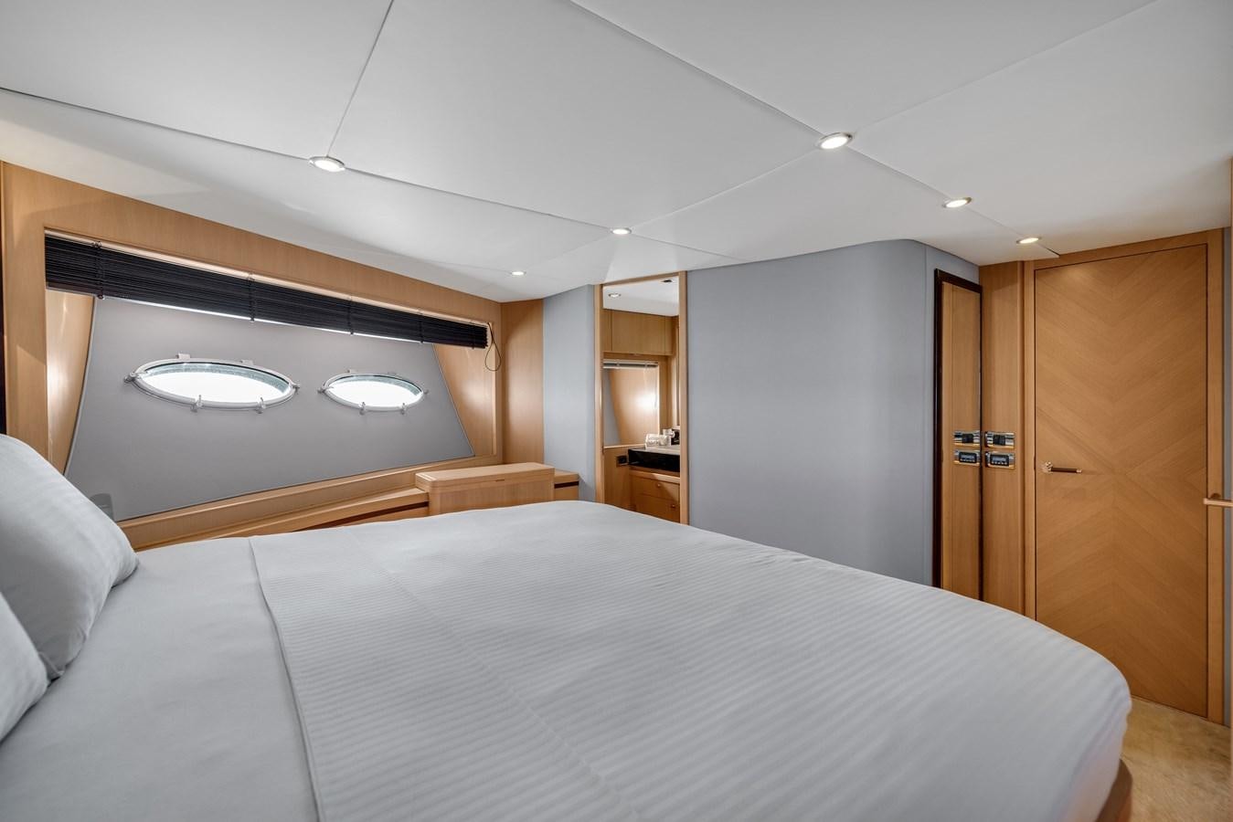a large bedroom with a large bed aboard PRINCESS 85 MY Yacht for Sale