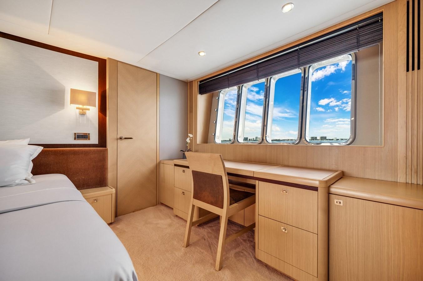 a room with a bed and a chair aboard PRINCESS 85 MY Yacht for Sale