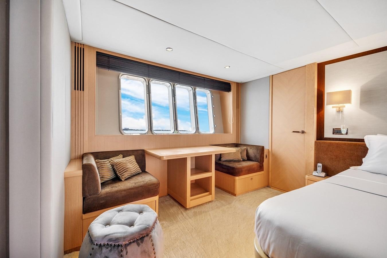 a room with a bed and a chair aboard PRINCESS 85 MY Yacht for Sale