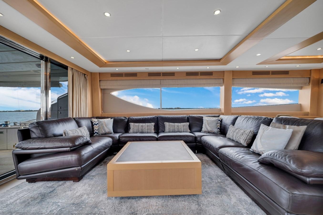 a living room with leather couches aboard PRINCESS 85 MY Yacht for Sale
