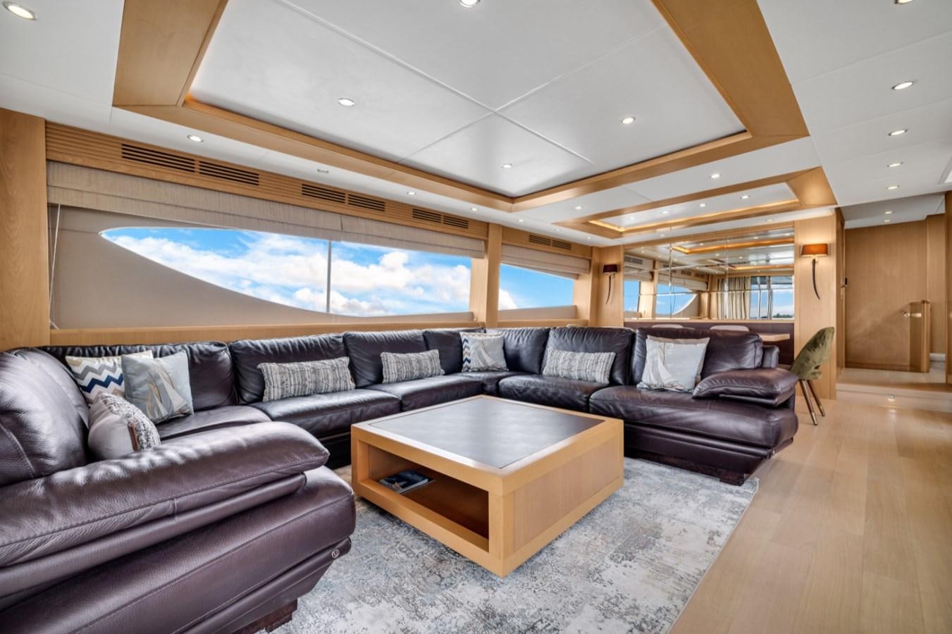 a living room with leather couches aboard PRINCESS 85 MY Yacht for Sale