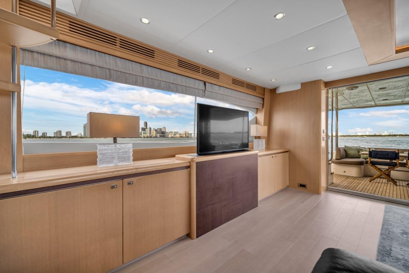 a room with a large window and a large television aboard PRINCESS 85 MY Yacht for Sale