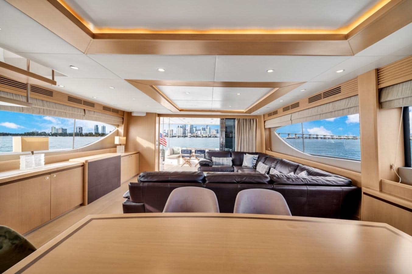 a large room with a couch and a large window aboard PRINCESS 85 MY Yacht for Sale