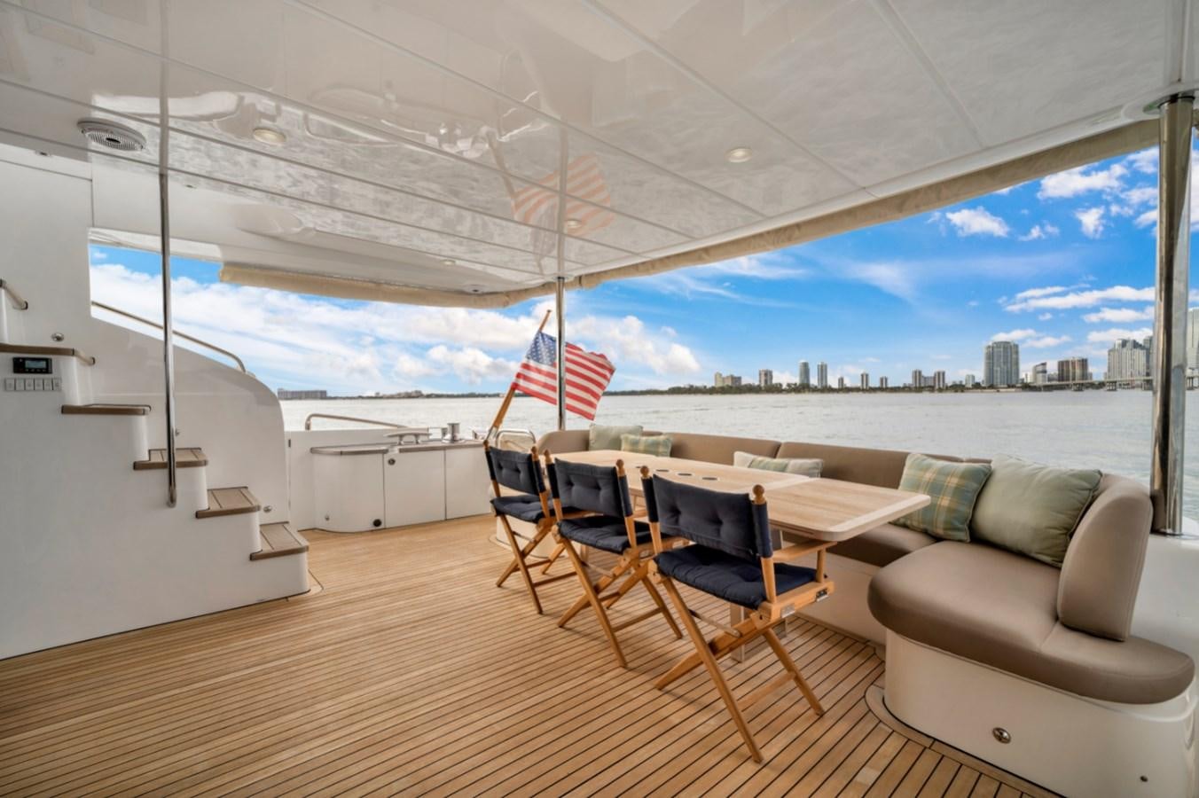 a room with a table chairs and a flag aboard PRINCESS 85 MY Yacht for Sale