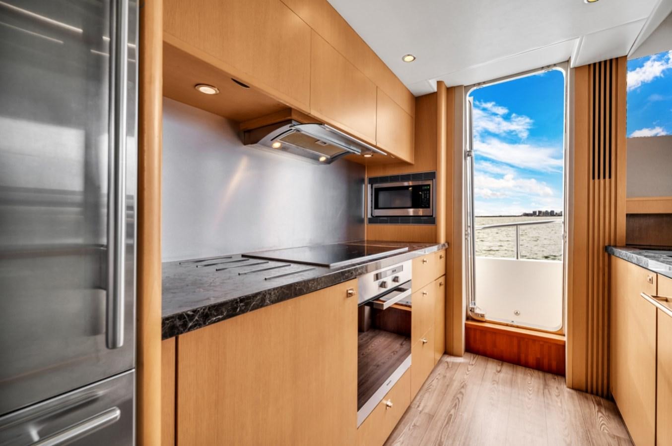 a kitchen with a large refrigerator aboard PRINCESS 85 MY Yacht for Sale