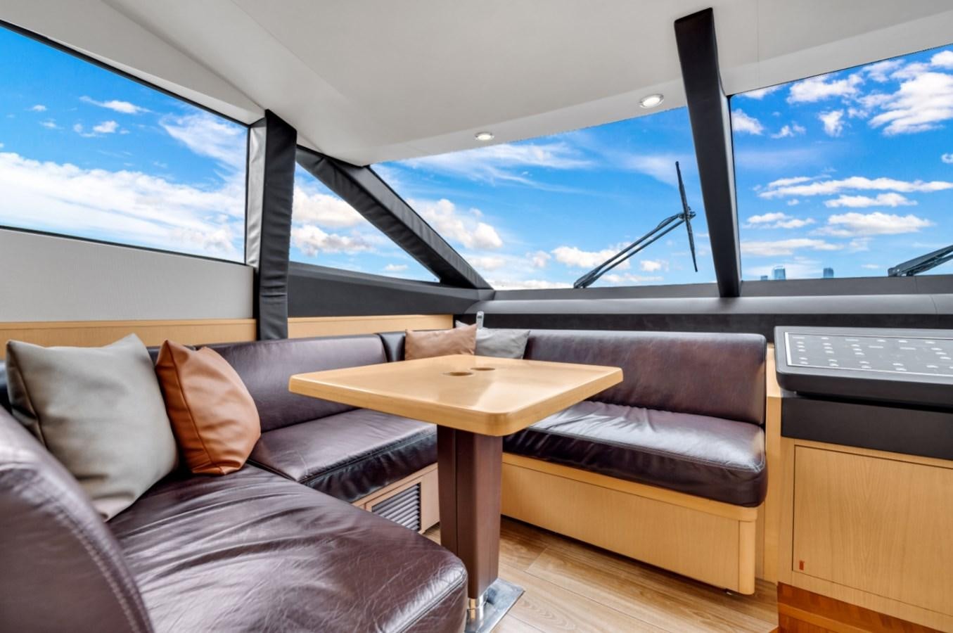 a room with a couch and a table and a large sailboat aboard PRINCESS 85 MY Yacht for Sale
