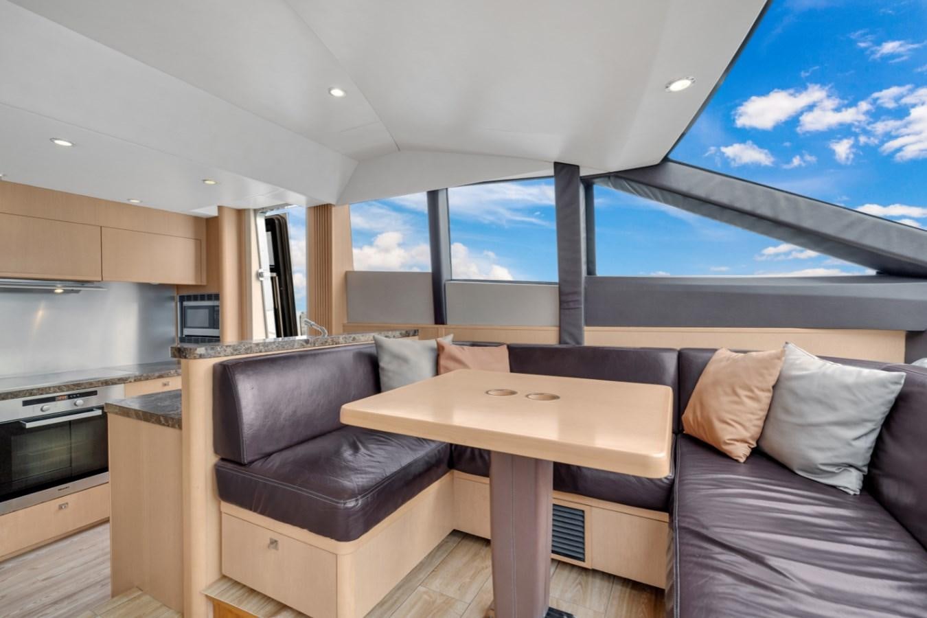 a room with a couch and a table aboard PRINCESS 85 MY Yacht for Sale
