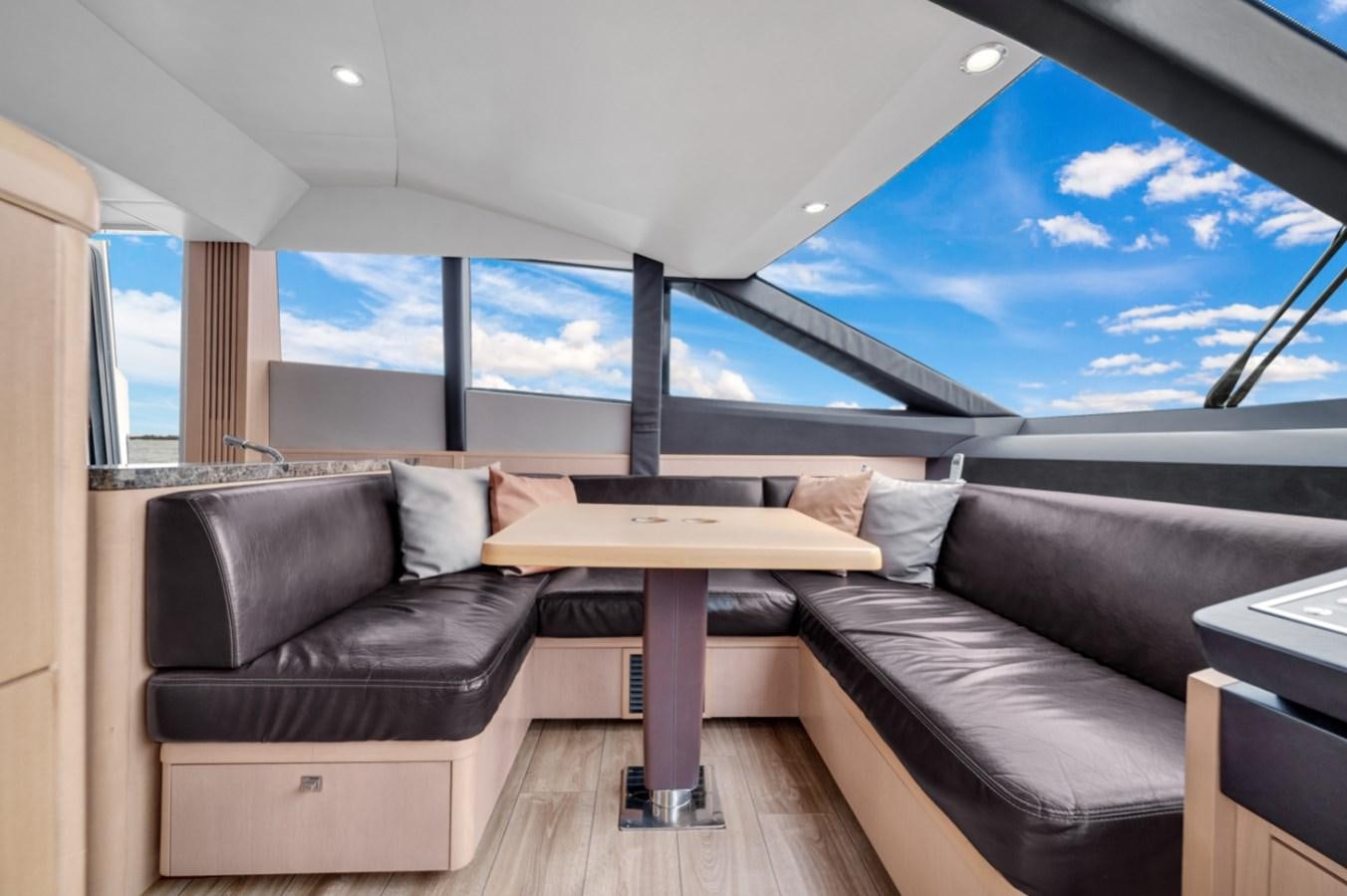 a room with a couch and a table aboard PRINCESS 85 MY Yacht for Sale