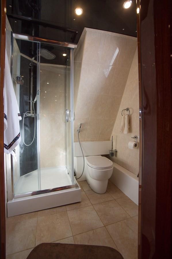 a bathroom with a glass shower aboard ANNA I Yacht for Sale