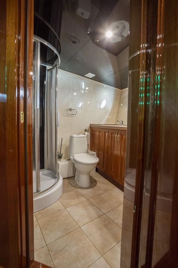 a bathroom with a toilet and shower aboard ANNA I Yacht for Sale