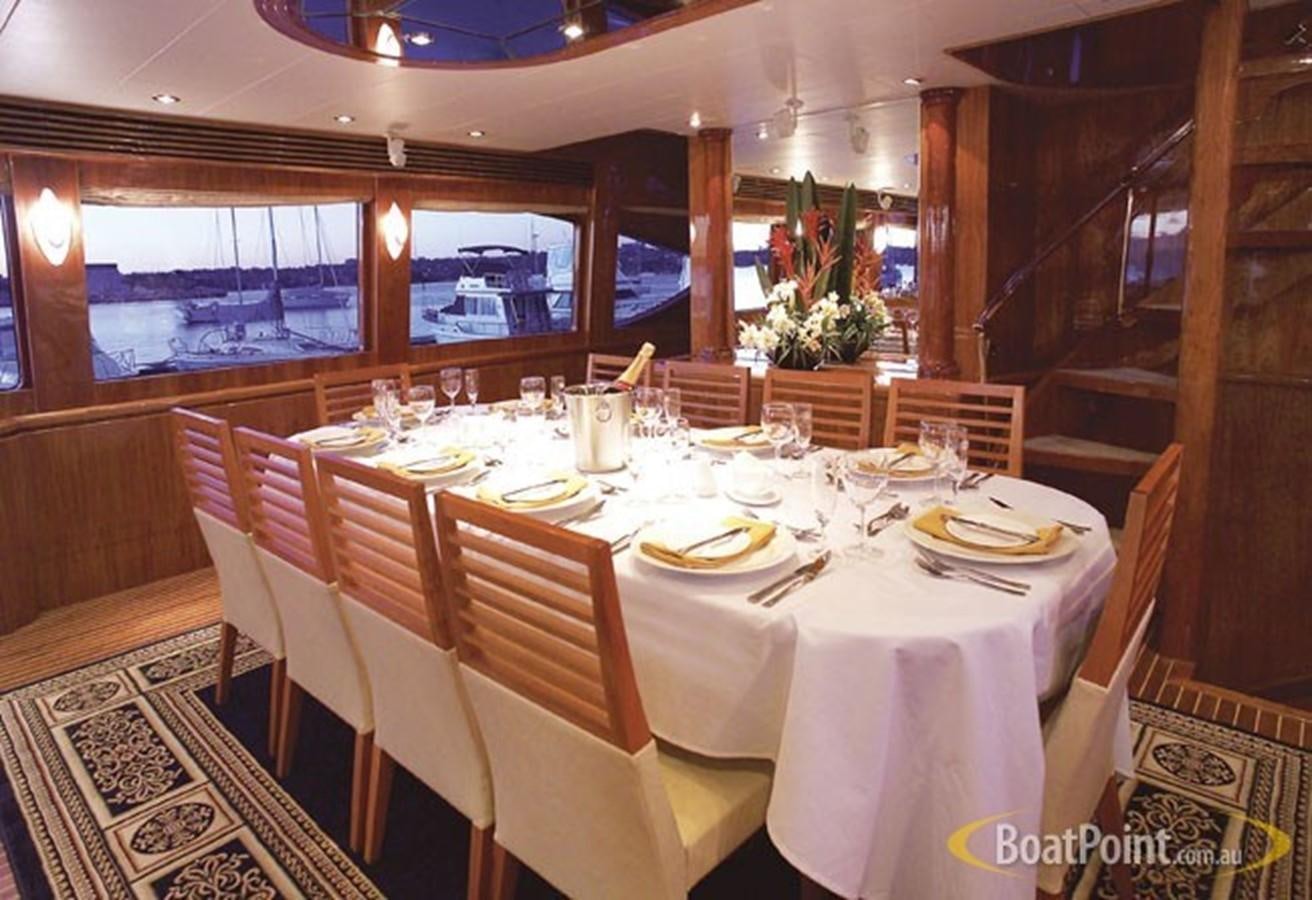 a table set for a meal aboard OCEANOS II Yacht for Sale