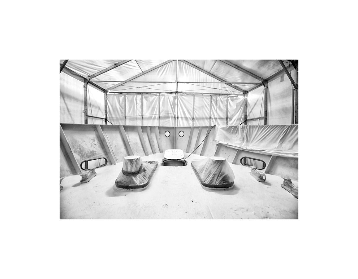 a black and white photo of a room with a bed and a fan aboard AUDACE 80 Yacht for Sale