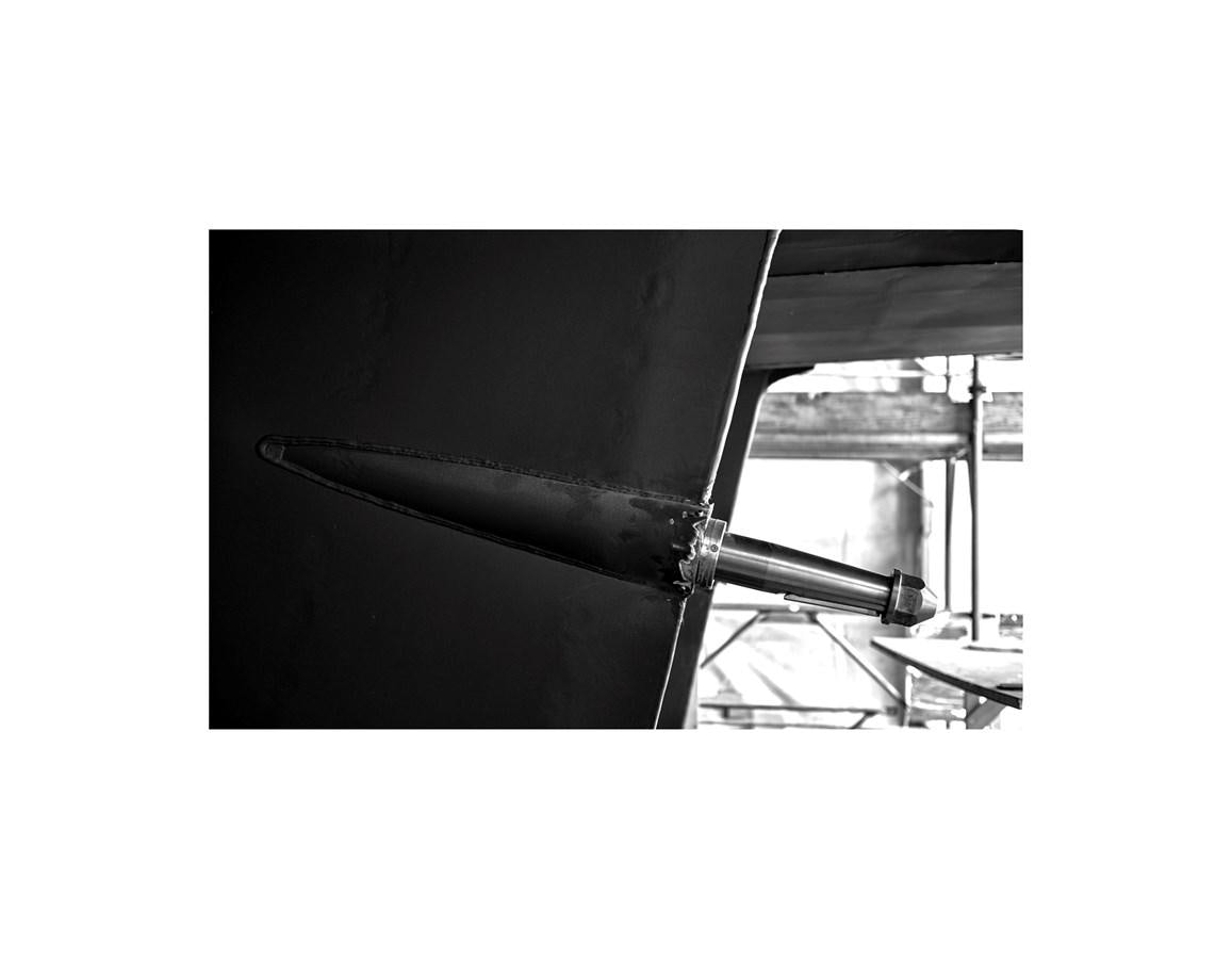 a black chair with a table aboard AUDACE 80 Yacht for Sale
