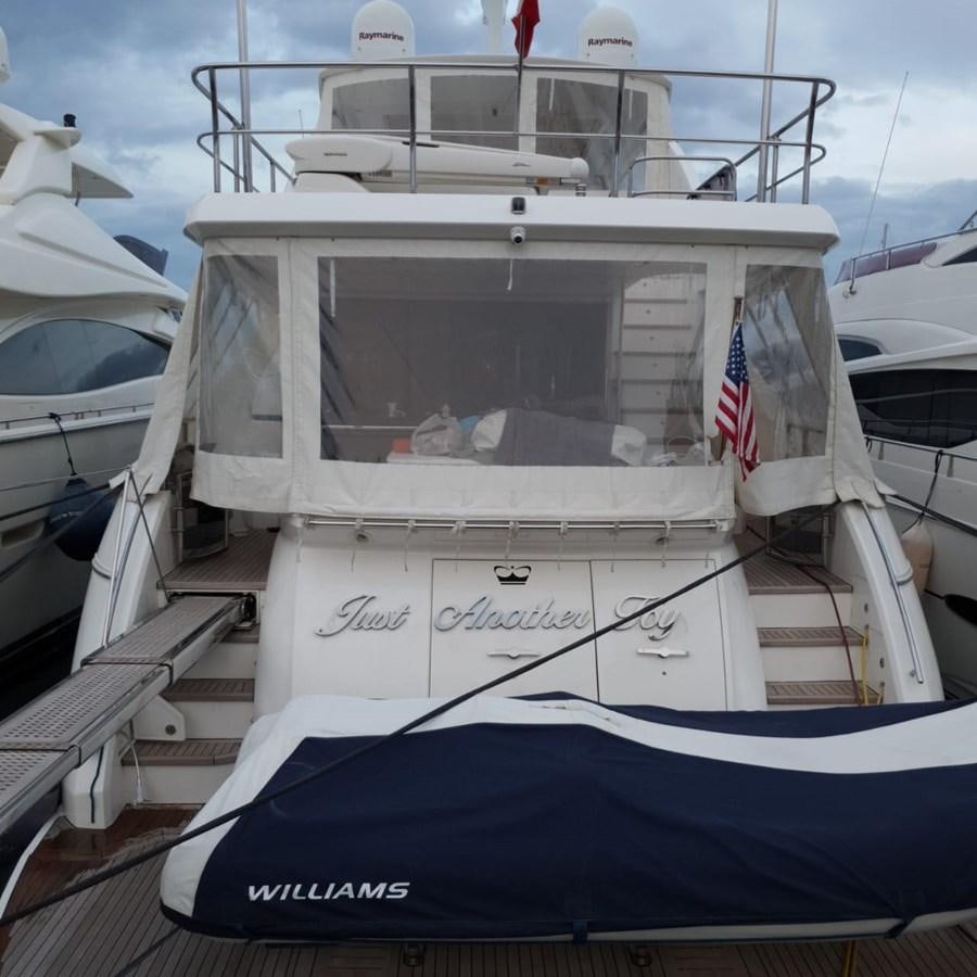a boat with a flag on the front aboard JUST ANOTHER TOY Yacht for Sale