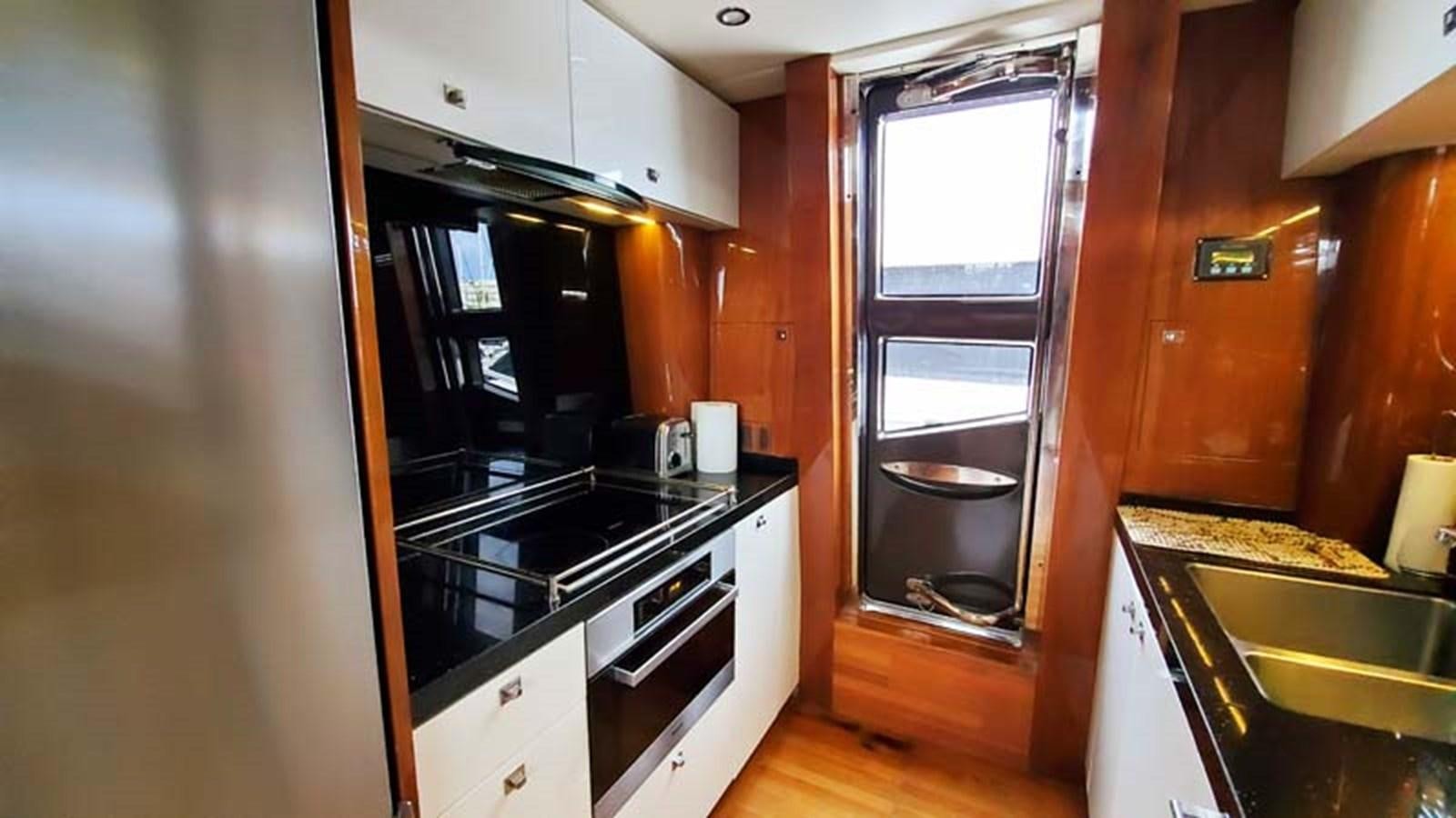 a kitchen with a glass door aboard AQUA CHAMELEON Yacht for Sale