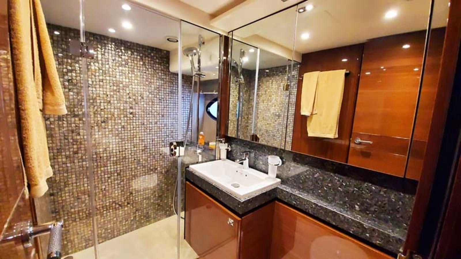 a bathroom with a large mirror aboard AQUA CHAMELEON Yacht for Sale