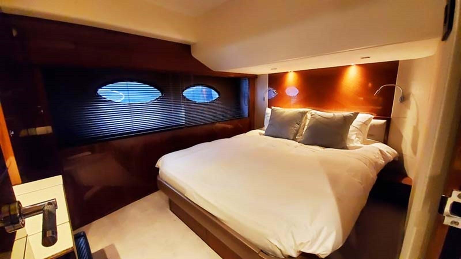 a bed with a white pillow aboard AQUA CHAMELEON Yacht for Sale