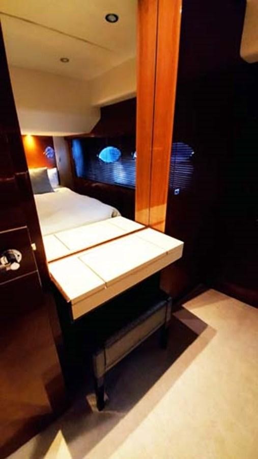 a room with a bed and a desk aboard AQUA CHAMELEON Yacht for Sale