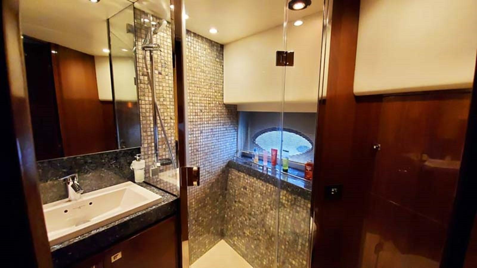 a bathroom with a large mirror aboard AQUA CHAMELEON Yacht for Sale