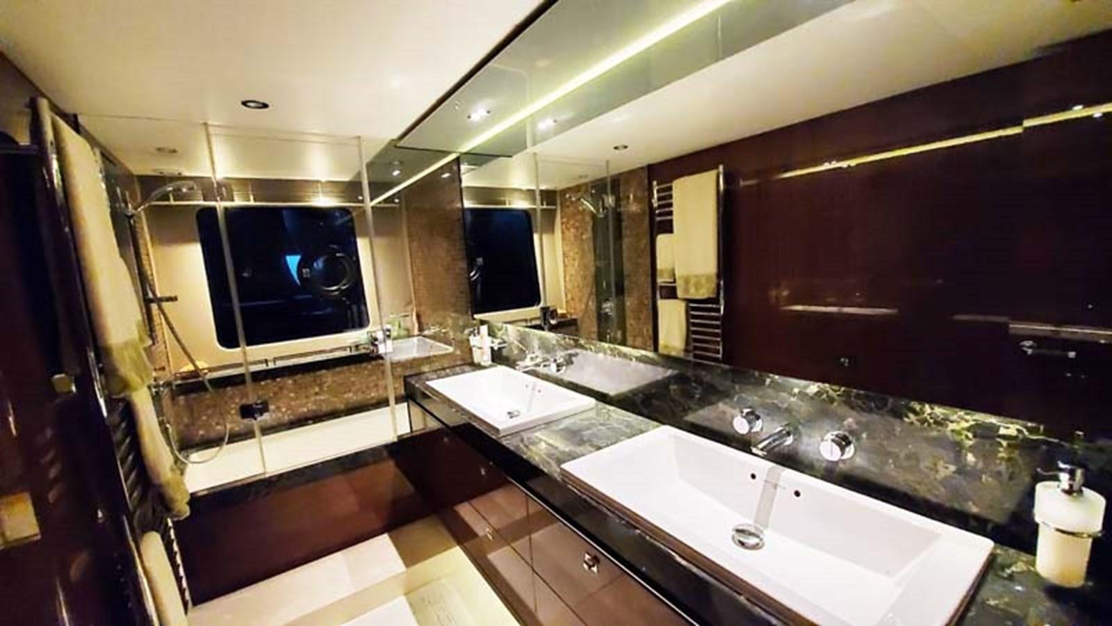 a bathroom with a large tv aboard AQUA CHAMELEON Yacht for Sale