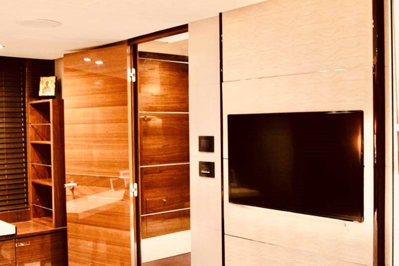 a room with a tv and a cabinet aboard AQUA CHAMELEON Yacht for Sale