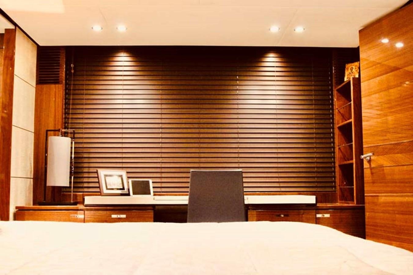 a room with a bed and a desk aboard AQUA CHAMELEON Yacht for Sale