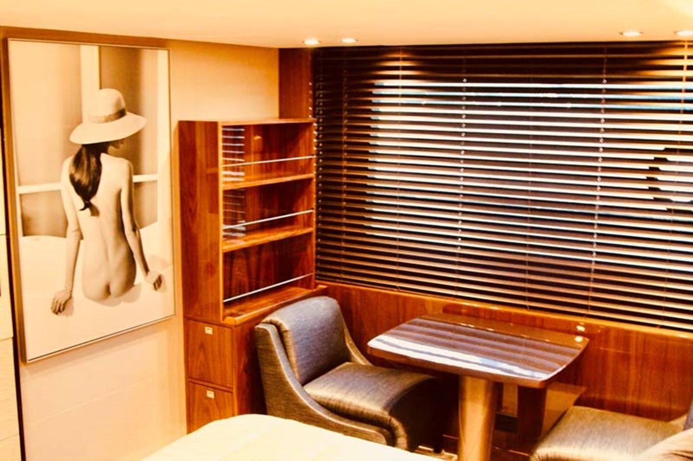 a room with a table and chairs aboard AQUA CHAMELEON Yacht for Sale
