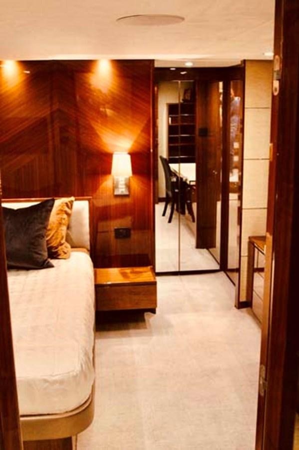 a bedroom with a bed and a mirror aboard AQUA CHAMELEON Yacht for Sale