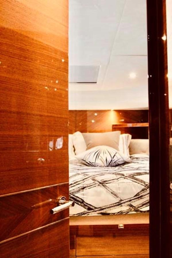 a bed with a white sheet aboard AQUA CHAMELEON Yacht for Sale