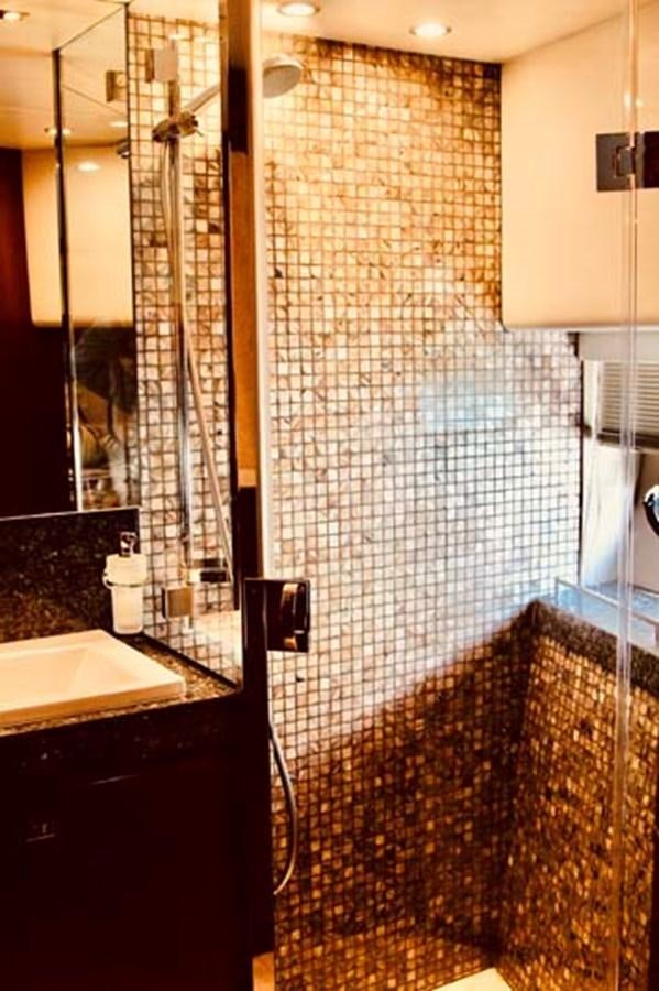 a bathroom with a shower unit and sink aboard AQUA CHAMELEON Yacht for Sale