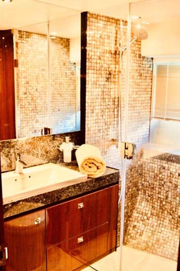 a bathroom with a sink and a shower aboard AQUA CHAMELEON Yacht for Sale