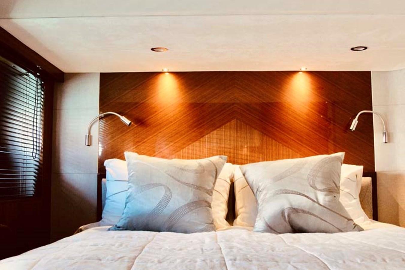 a bed with a white comforter and pillows aboard AQUA CHAMELEON Yacht for Sale