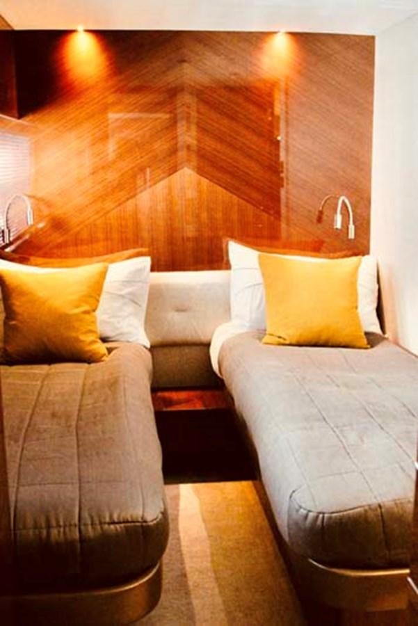 a bed with a couch aboard AQUA CHAMELEON Yacht for Sale