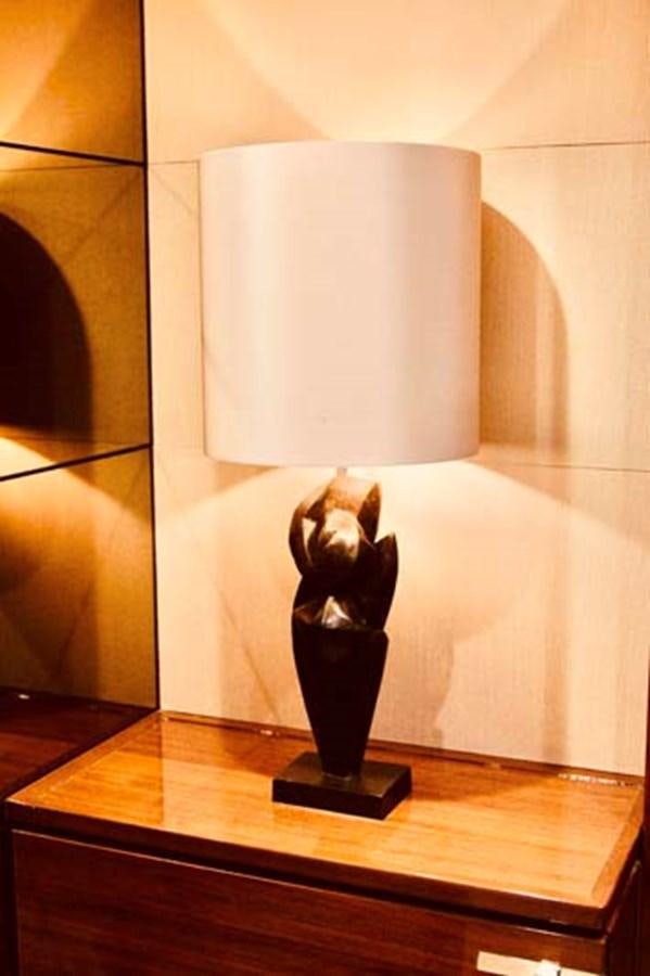 a white candle on a table aboard AQUA CHAMELEON Yacht for Sale