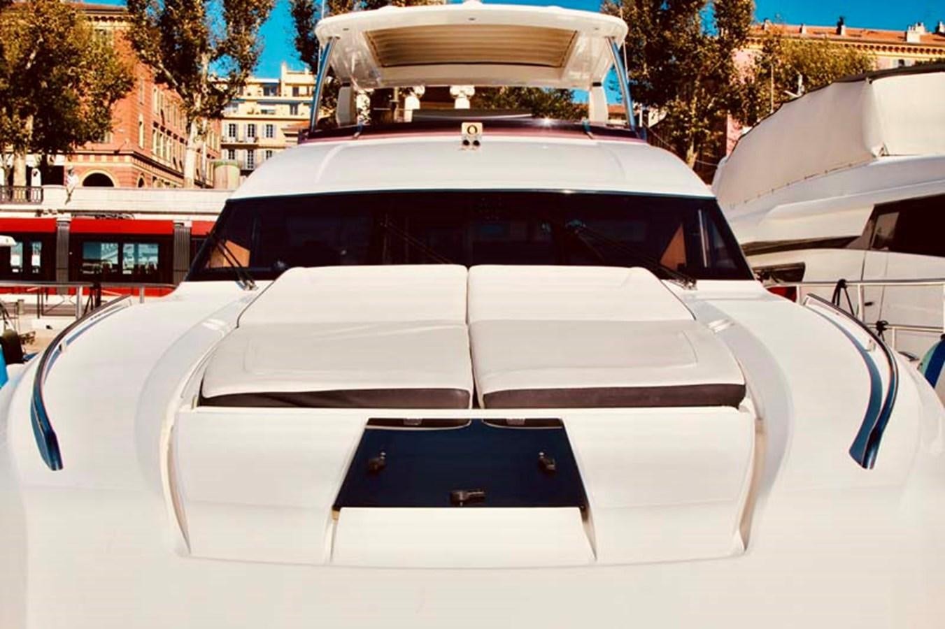 a white car with a black door aboard AQUA CHAMELEON Yacht for Sale