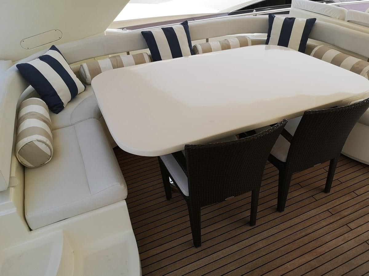 a table with chairs around it aboard RICACHA 2012 FERRETTI 830 @ ACAPULCO Yacht for Sale