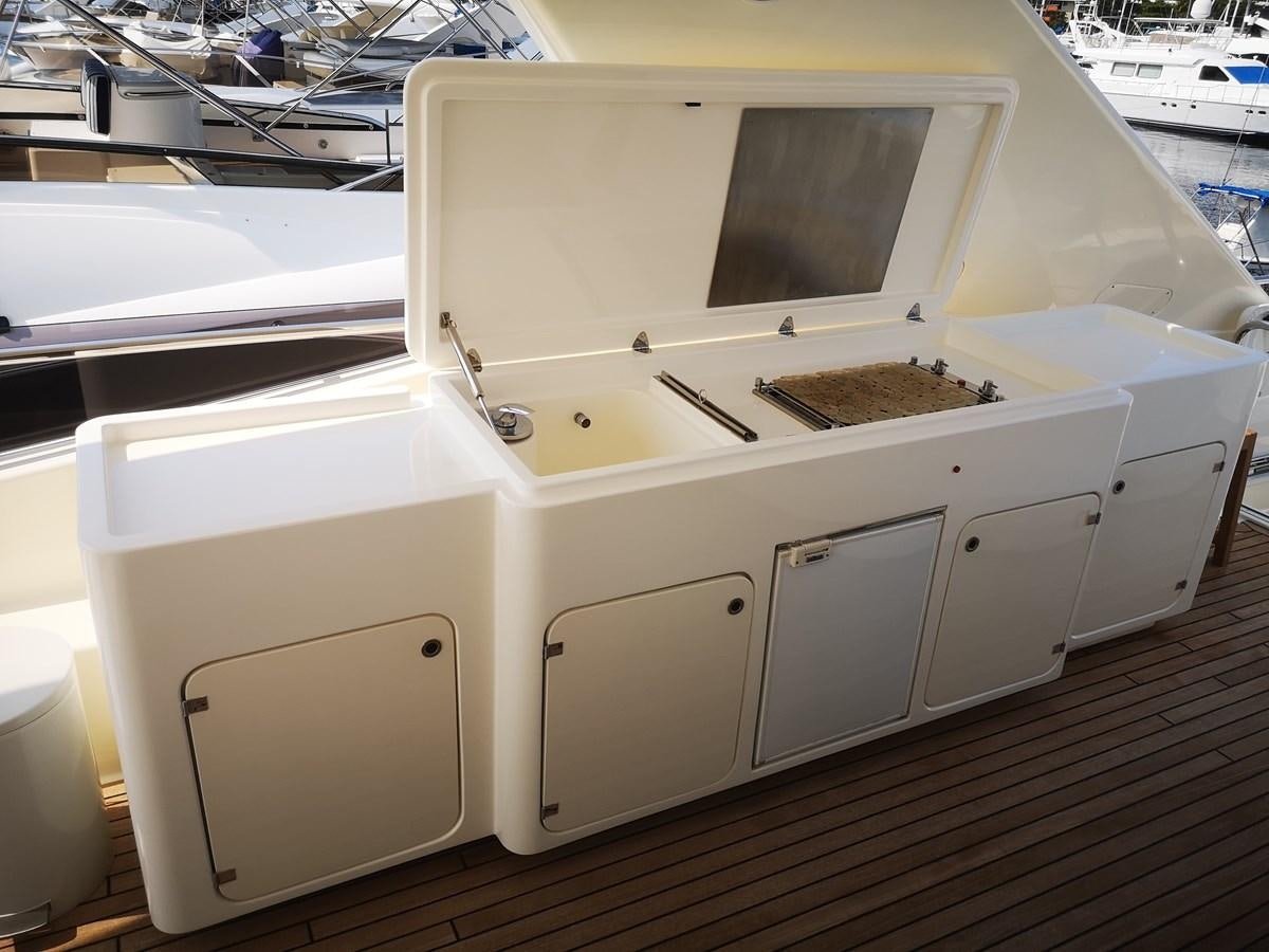 a white machine with a black handle aboard RICACHA 2012 FERRETTI 830 @ ACAPULCO Yacht for Sale