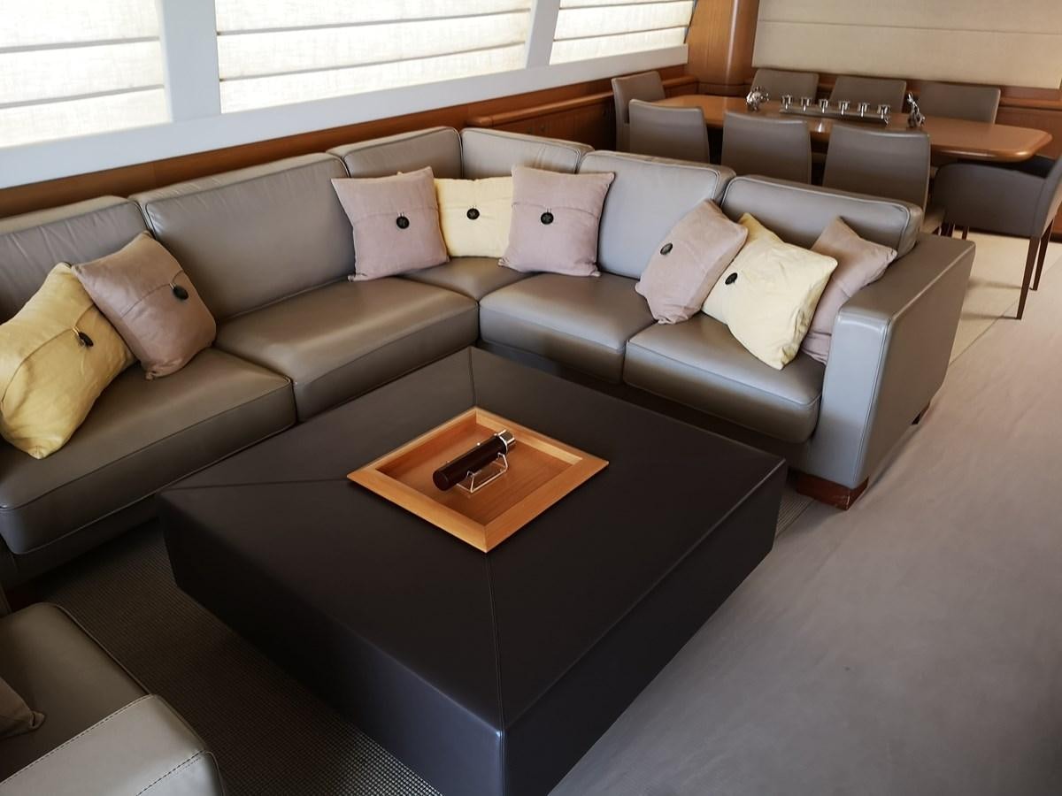 a couch with a coffee table aboard RICACHA 2012 FERRETTI 830 @ ACAPULCO Yacht for Sale