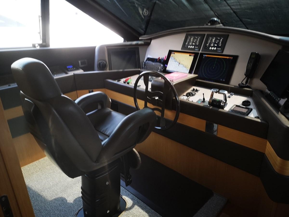 a room with a desk and a chair aboard RICACHA 2012 FERRETTI 830 @ ACAPULCO Yacht for Sale