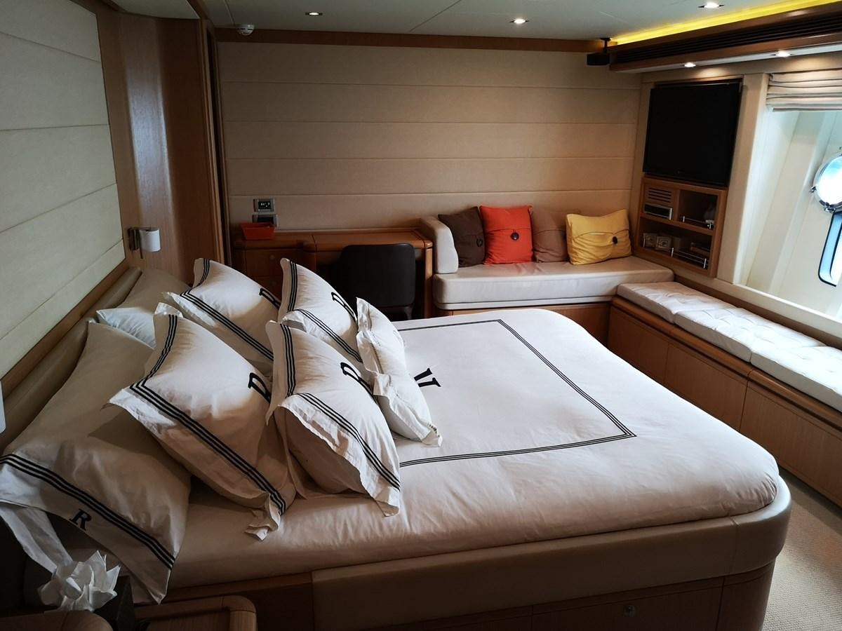 a room with a bed and a window aboard RICACHA 2012 FERRETTI 830 @ ACAPULCO Yacht for Sale