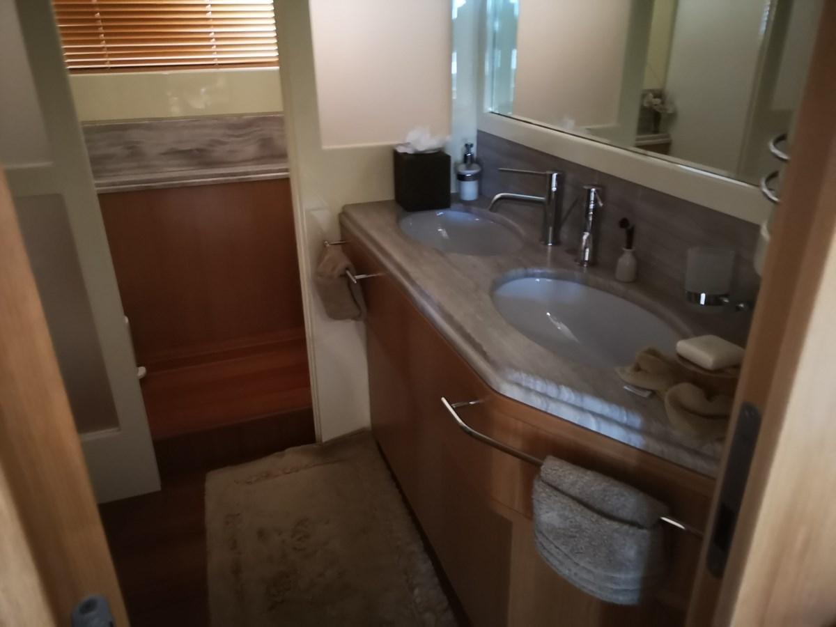 a bathroom with a sink and a mirror aboard RICACHA 2012 FERRETTI 830 @ ACAPULCO Yacht for Sale