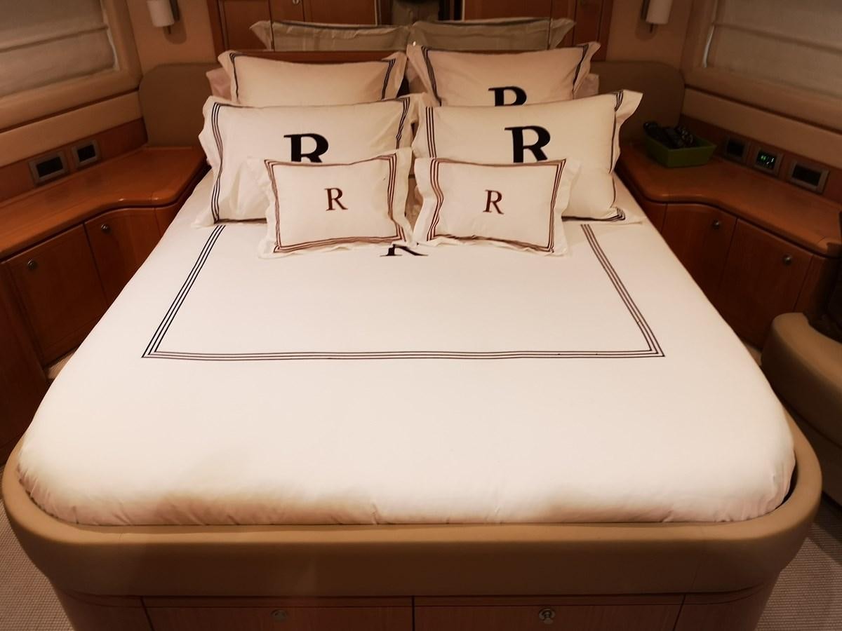 a bed with white pillows aboard RICACHA 2012 FERRETTI 830 @ ACAPULCO Yacht for Sale