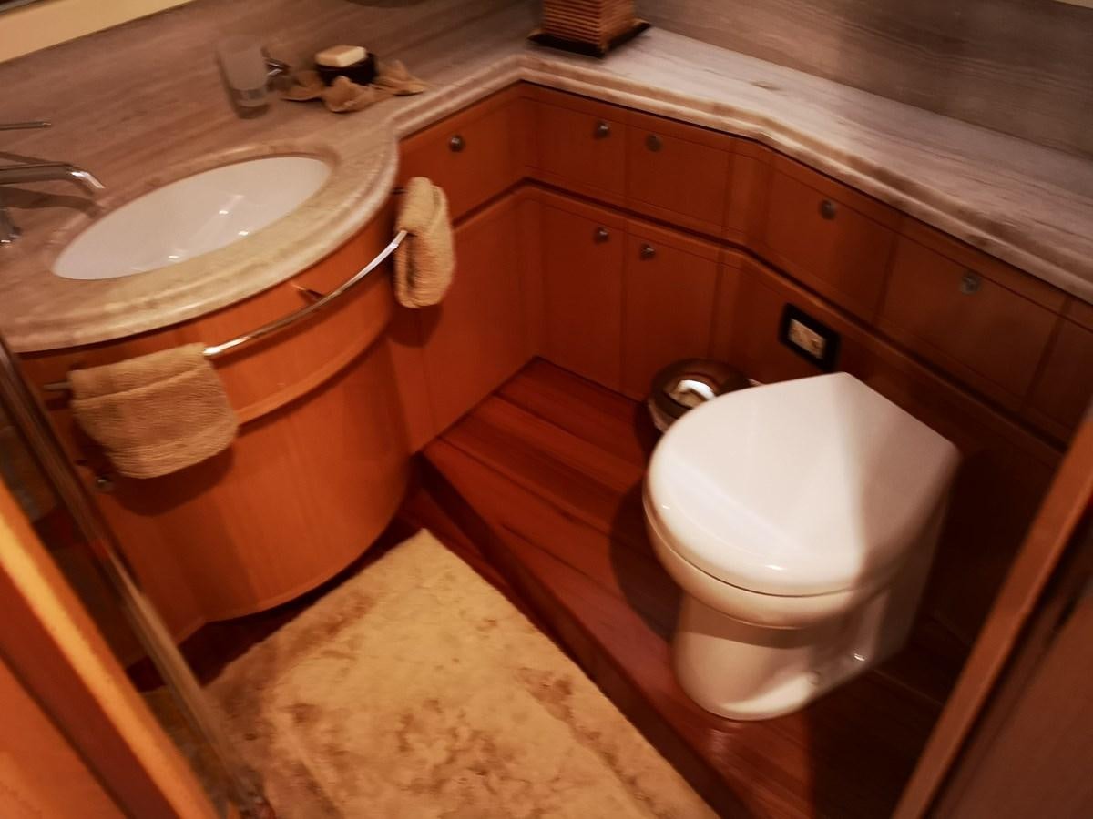 a bathroom with a sink and toilet aboard RICACHA 2012 FERRETTI 830 @ ACAPULCO Yacht for Sale