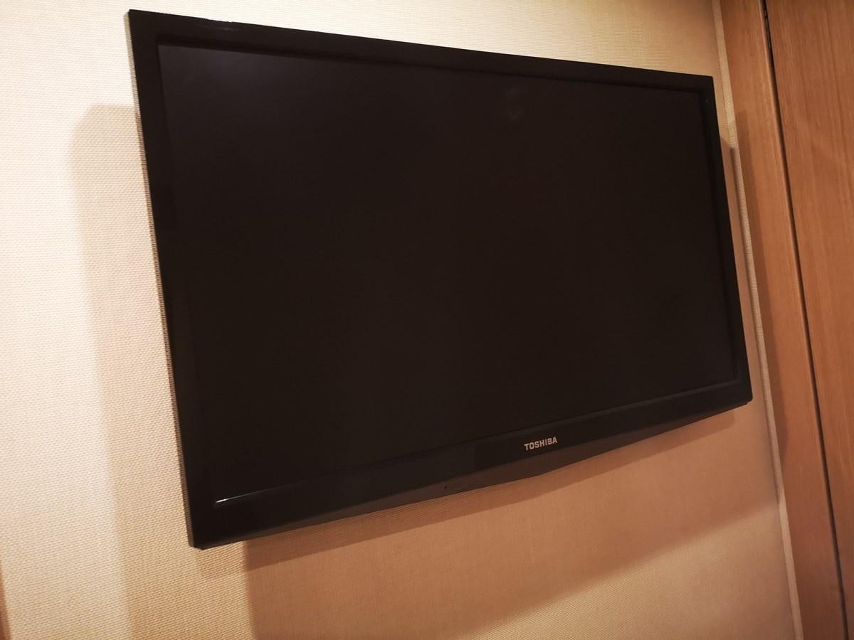 a black television on a white wall aboard RICACHA 2012 FERRETTI 830 @ ACAPULCO Yacht for Sale