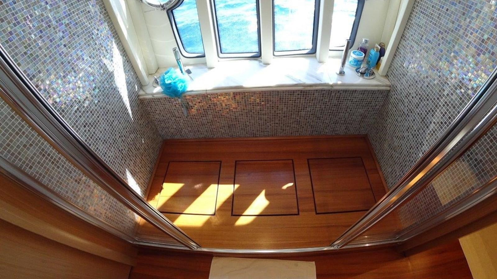 a room with a window and a wood floor aboard CHUPRIANA Yacht for Sale