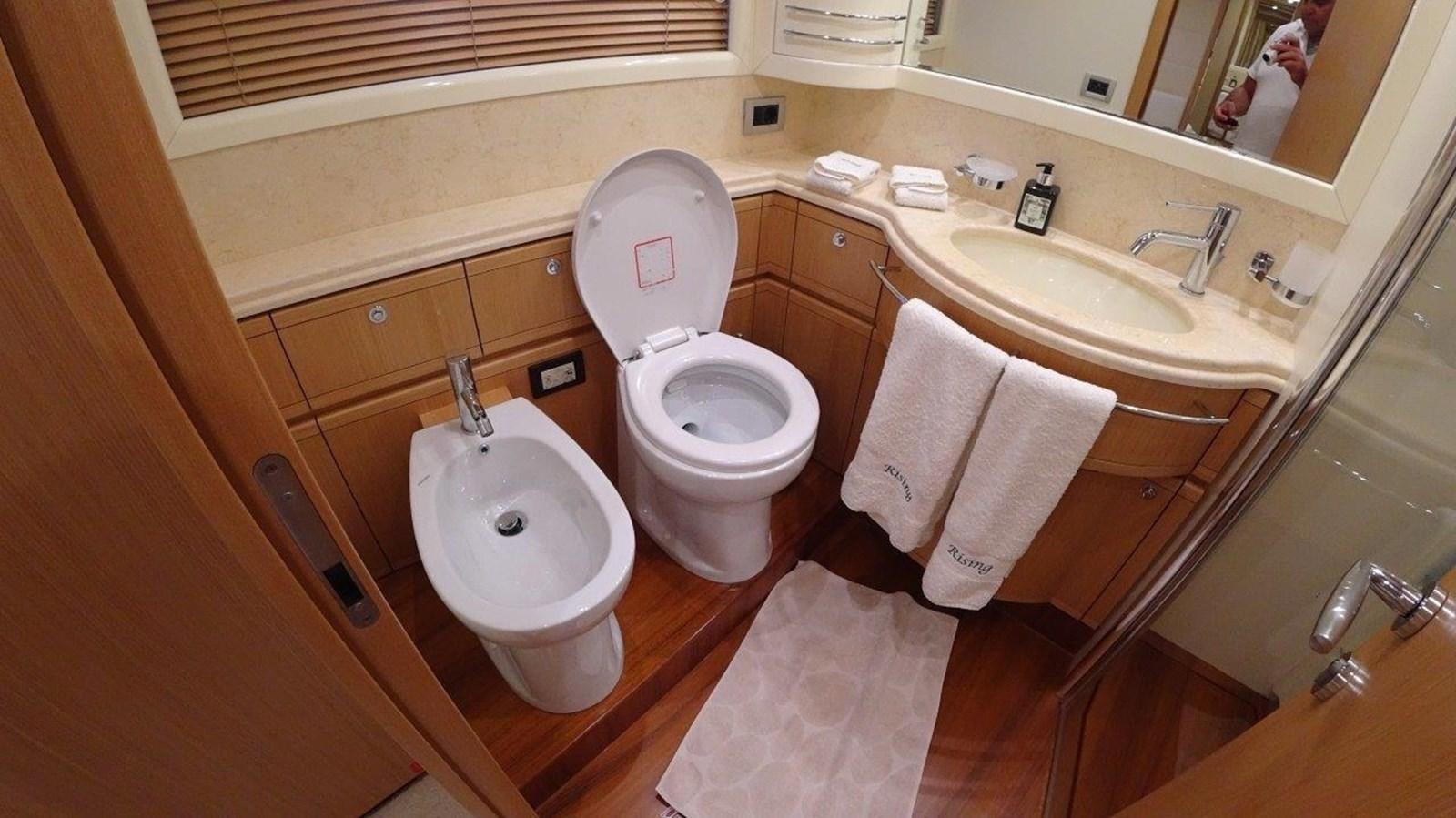 a bathroom with a toilet and sink aboard CHUPRIANA Yacht for Sale