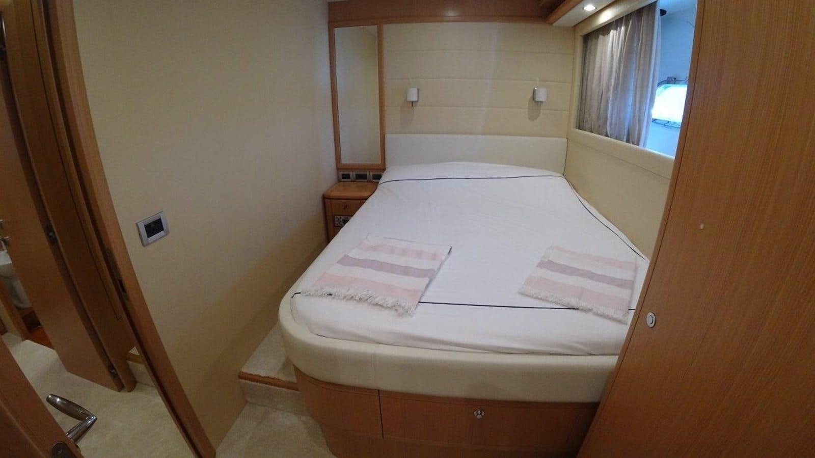 a white bed with a white sheet on it aboard CHUPRIANA Yacht for Sale