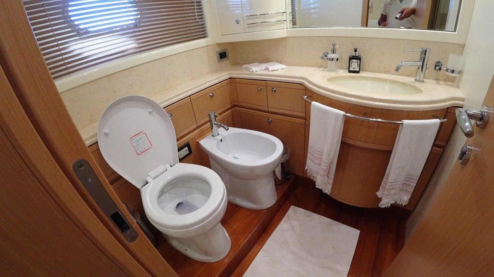 a bathroom with a toilet and sink aboard CHUPRIANA Yacht for Sale