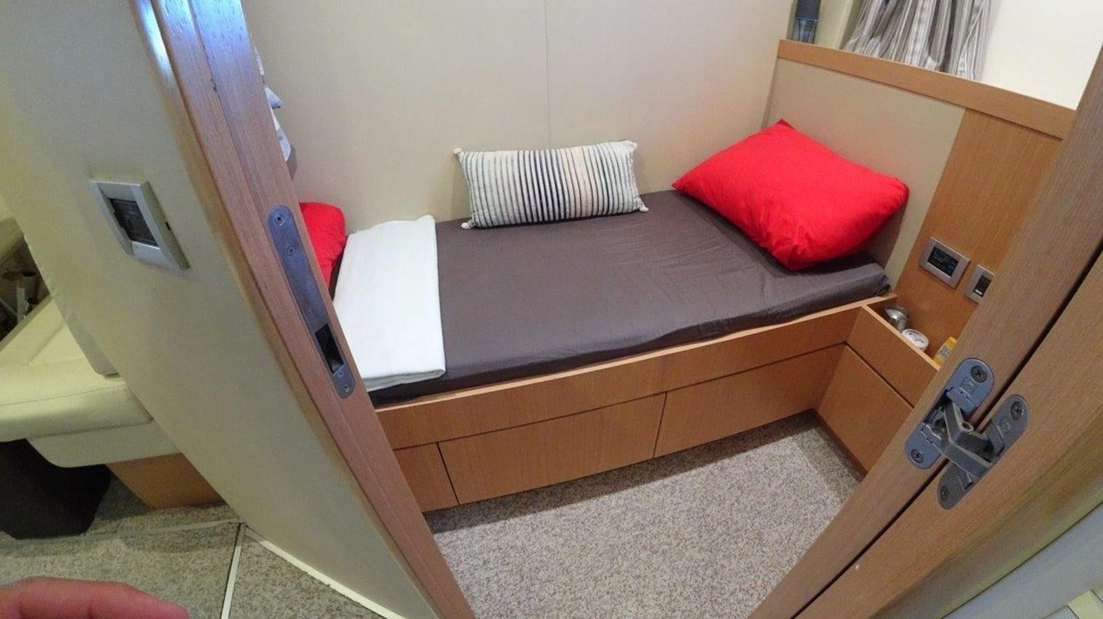 a bed with a red pillow aboard CHUPRIANA Yacht for Sale